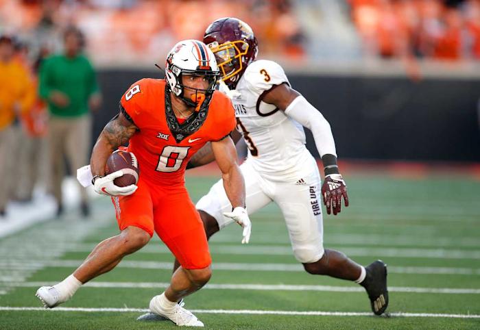 OSU's Braydon Johnson (8) catches a pass as Central Michigan's Trey Jones (3) defend in the first quarter.